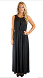 A woman modeling a sleeveless black maxi dress with a gathered neckline and a flowing skirt, standing against a plain white background.