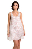 A woman modeling a sleeveless white nightgown with a delicate floral lace pattern against a solid white background.